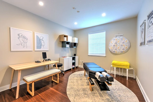 A treatment room at Life Family Chiropractic with an adjustment table and scanning technology