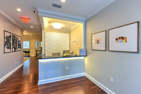 The front desk at Life Family Chiropractic with warm inviting light in an open lobby