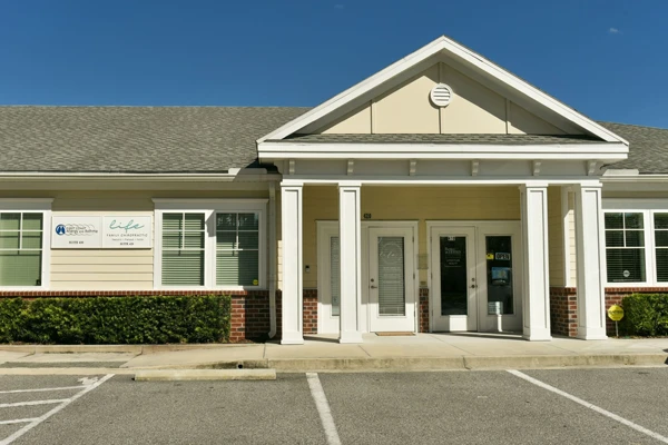 The clinic exterior of Life Family Chiropractic. There is plenty of parking space for patients
