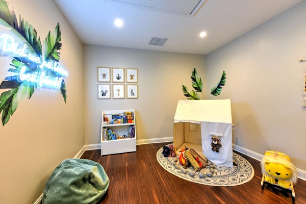 A children's play room at Life Family Chiropractic with a play tent and a reading corner