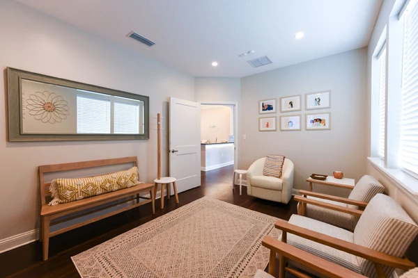 A family waiting room at Life Family Chiropractic with comfortable chairs and benches for patients