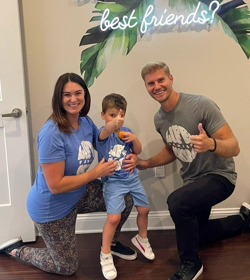 Chiropractor Nocatee FL Brett Lukas Thumbs Up HP Dr. Brett Lukas, a pediatric patient, and the patient's mother all giving a thumbs-up gesture to the camera