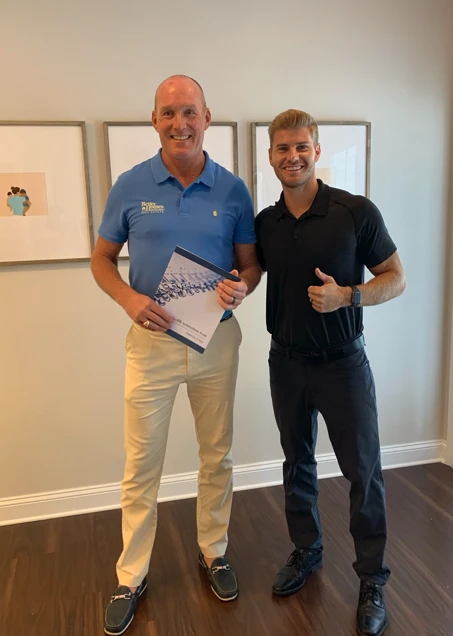 Chiropractor Ponte Vedra Beach FL Brett Lukas With Happy Patient Dr. Brett Lukas with an adult patient, please with the treatment he received